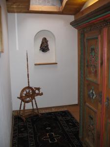 a room with a table and a chair and a wall at Ferienwohnung Maria im Landhaus Christina in Alpbach +10 photos