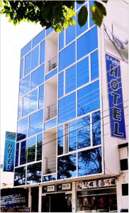 a building with a blue sign on the side of it at Hotel Azulejo del Llano in Yopal
