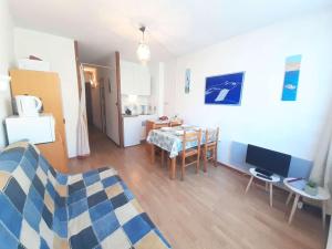 a living room with a table and a dining room at Studio Piau-Engaly, 1 pièce, 4 personnes - FR-1-457-307 in Aragnouet