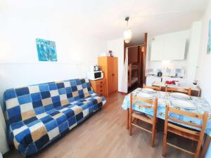 a living room with a couch and a table at Studio Piau-Engaly, 1 pièce, 4 personnes - FR-1-457-307 in Aragnouet