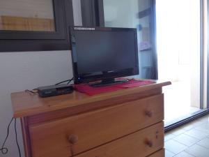 a tv sitting on top of a dresser with a television on it at Studio Le Lavandou, 1 pièce, 2 personnes - FR-1-308-161 in Le Lavandou