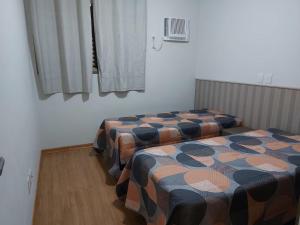 A bed or beds in a room at Apartamento Olimpia - Próximo ao Parque Thermas dos Laranjais - Ideal para familias