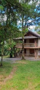 a large house with trees in front of it at Cabana Drechsler Gramado in Gramado