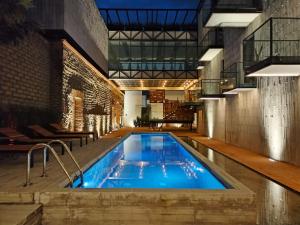a pool in the middle of a building at Hotel Tila in Cholula