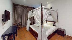 a bedroom with a canopy bed and a piano at Armenian Suite in George Town