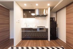 a kitchen with a sink and a refrigerator at HIZ HOTEL - Vacation STAY 08966v in Tokyo