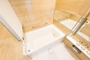 a small bathroom with a tub and a sink at HIZ HOTEL - Vacation STAY 18549v in Tokyo +10 photos