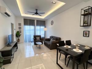 a living room with a couch and a table at Ins Apartment Langkawi Simfoni Beliza KUAH in Kuah