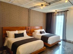 Un pat sau paturi într-o cameră la Hotel Tila