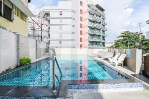 a swimming pool on the balcony of a building at The ESSE Hotel Pattaya in Pattaya South