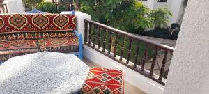 a balcony with a couch and a table at Delta Sharm appartment Shahrazad in Sharm El Sheikh