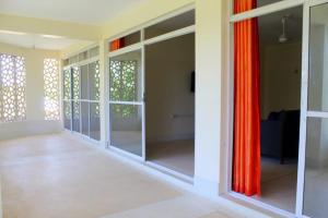 a room with sliding glass doors in a house at Vee's Villa in Kilifi