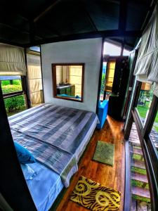 a bedroom with a large bed in a house at Kolonne RIverside Garden Hotel in Avissawella