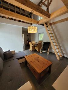 a living room with a couch and a table at Haus Evelynchen Apartment 2 Deutschhof in Deutschhof +17 photos