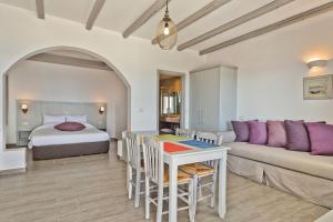a living room with a bed and a couch and a table at Alsalos Villas in Amoopi