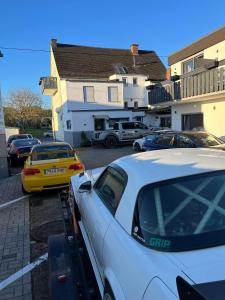 a group of cars parked in a parking lot at Vina am ring Apartment in Mannebach