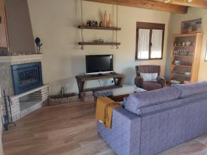 a living room with a couch and a fireplace at UN RINCÓN EN LA MORAÑA in Avila