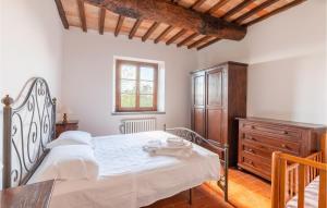 a bedroom with a bed and a wooden dresser at Mandorli in Monte Santa Maria Tiberina