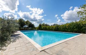 a swimming pool in a backyard with a gazebo at Mandorli in Monte Santa Maria Tiberina