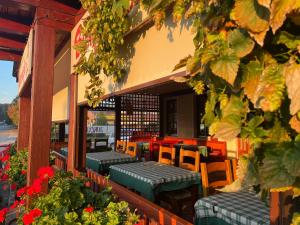 ein Restaurant mit grünen Tischen, Stühlen und Blumen in der Unterkunft Guesthouse Jurcek in Zreče