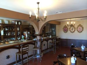 a bar in a restaurant with tables and chairs at El Porton de la Huebra in Vecinos