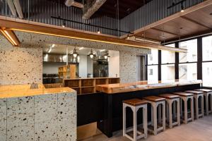 a restaurant with a bar with stools at ArC LIFESTYLE SPACE & HOTEL in Mito