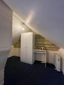 an attic room with a desk in the attic at Shared House in Chakeshill Drive in Bristol