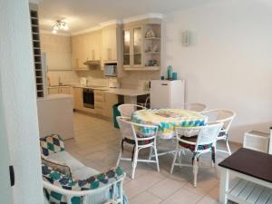 a kitchen and dining room with a table and chairs at Eden Wilds Unit 8 in Port Edward