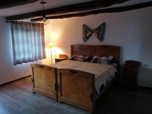 a bedroom with a bed with a butterfly on the wall at Borlova /Muntele Mic in Borlova
