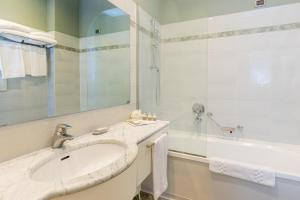 سكن دي لا غاره في ميلانو: حمام أبيض مع حوض وحوض استحمام