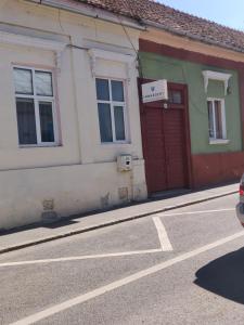 a building with a red door on the side of a street at Cluj Center in Cluj-Napoca