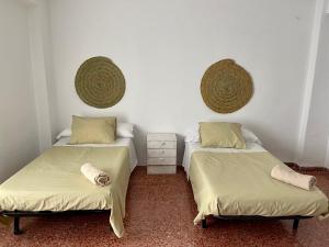 two beds sitting next to each other in a room at La Nana in Castril