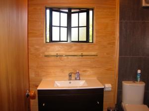a bathroom with a sink and a window at Ngauruhoe Yurt - Ohakune Holiday Home in Ohakune +19 photos