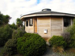 un pequeño edificio de madera con techo en Ngauruhoe Yurt - Ohakune Holiday Home en Ohakune