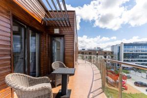 a balcony with a table and chairs on a building at Apartament Baltic Plaza 316 in Kołobrzeg