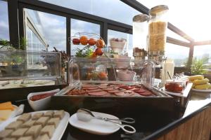 a buffet with meats and other food on a counter at Old Meidan Tbilisi By Urban Hotels in Tbilisi City