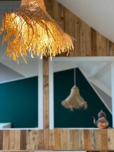 a piece of straw is hanging from a ceiling at Chateau Brulant in Somme-Leuze