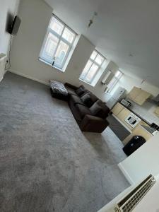 an empty living room with two couches and two windows at 2 bedroom flat in kingswood in Bristol