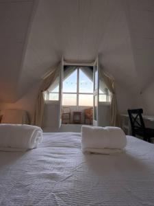 a large white bed with two pillows on top of it at Edwardian Villa by the Sea Coastal Walks King Beds in Walton-on-the-Naze