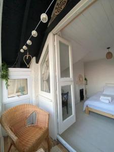 a bedroom with a bed and a chair and a window at Edwardian Villa by the Sea Coastal Walks King Beds in Walton-on-the-Naze