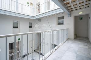 a room with a balcony in a building at Apartamento El Mirador del Paso (Feel Cádiz) in Cádiz