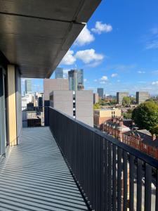 a balcony with a view of the city at 2 bedroom with big balcony and gym in Manchester