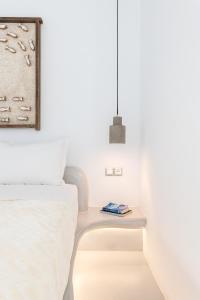 A bed or beds in a room at Yalos mykonos 3 bedroom Luxury home in Mykonos Town with Sea & Sunset view