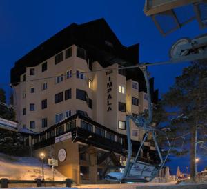 a large hotel building in the snow at night at Apartamento Superior Sierra Nevada in Sierra Nevada