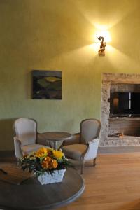 a living room with a table and chairs and a fireplace at Casapecchenino in Dogliani