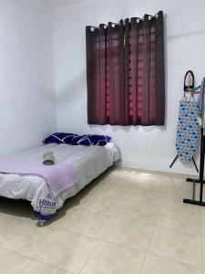a bedroom with a bed and a window in a room at Azfar Homestay in Kangar