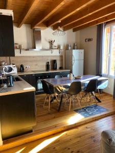 a kitchen with a table and chairs in a room at Maison Fontrabiouse in Fontrabiouse