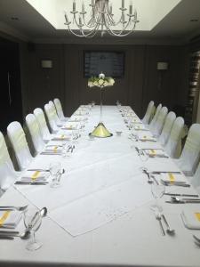 a white table topped with white plates filled with food at Dumfries Arms Hotel in Cumnock