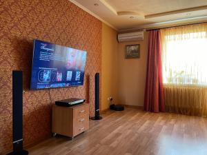 ein Wohnzimmer mit einem Flachbild-TV an der Wand in der Unterkunft Boryspil Airport Luxury apartment in Boryspil