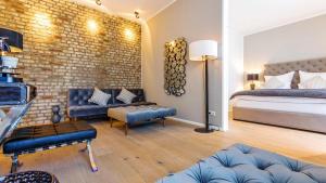 a bedroom with a bed and a brick wall at Refugium de Luxe Messe-Deutz in Cologne +17 photos